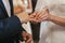 beautiful bride and groom hands exchanging wedding rings in church during wedding ceremony. spiritual holy matrimony. wedding