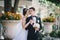 Beautiful bride and groom posing in a yard of a castle