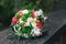 Beautiful bride is holding a wedding colorful bouquet. Beauty of colored flowers. Close-up bunch of florets.