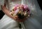 Beautiful bride holds wedding bouquet