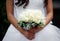 Beautiful bride holds wedding bouquet