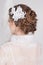 Beautiful bride with lace flowers in her gorgeous dark blond hair. High wedding hairstyle, braids and curls