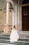 Beautiful bride in a long dress climbs the steps of Santa Maria Maggiore, Rome, Italy