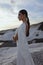 beautiful bride in luxurious wedding dress posing on the beach in Cyprus