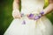 Beautiful bride in luxurious wedding dress with purple lavender fl