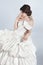 Beautiful bride model woman wearing in wedding dress with voluminous skirt, studio photo