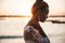 Beautiful bride posing on the beach behind sea at sunset