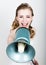 Beautiful bride screaming into a bullhorn. Wedding day. funny bride concept