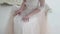 Beautiful bride sitting on a chair, a lush lace skirt closeup. Touches skirt hands. Wedding dress