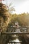 Beautiful bride standing on wooden rustic bridge at sunset time