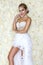 Beautiful bride in a stunning wedding dress with lace. Beauty young woman on a background of roses - Image