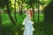 Beautiful bride in summer park. Redhead girl in vintage dress.