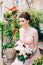 beautiful bride in tender wedding dress with bridal bouquet is sitting on the porch of the house in Perast