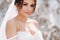 Beautiful bride in a wedding dress with a bouquet on the top of the salt mountains. A stunning young bride with curly hair .