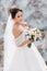 Beautiful bride in a wedding dress with a bouquet on the top of the salt mountains. A stunning young bride with curly hair .