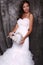 Beautiful bride in wedding dress holding decorative heart