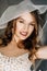 Beautiful bride in white dress posing under curtain