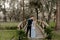 Beautiful Bridesmaid Woman in Blue Dress and Bouquet with Her Date at a Formal Wedding Party Celebration Event Outside in the Wood