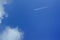 Beautiful bright blue sky with with a flying plane. clouds. picturesque colorful