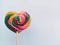 Beautiful bright colorful lollipops like a rainbow shaped like a heart isolated on a white background