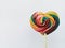 Beautiful bright colorful lollipops like a rainbow shaped like a heart isolated on a white background