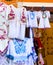 Beautiful bright ethnic shirts and tablecloths with traditional Hungarian embroidery in a street store.