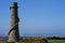 Beautiful bright horizontal view of Ballycorus lead mining and smelting chimney tower against clear blue sky, Ballycorus
