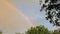 A beautiful bright rainbow formed in the sky after rain
