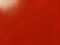 Beautiful bright red background. Closeup sheet of shiny reflecting incident light paper. Pure fun color. Intense shade of red,