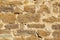 Beautiful bright sandstone wall of an old farm without vegetation with many different sized joints and different sized stones and