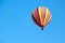 Beautiful bright striped balloon against the blue sky. Travel dr