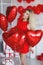 Beautiful bright woman with red balloons on Valentine`s day