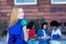 Beautiful british female student with red hair and group of students