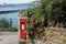 Beautiful Brixham seascape with a red letterbox in the foreground in  Brixham Devon looking out to sea