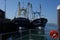 Beautiful Brixham seascape with two fishing trawlers in the harbour Brixham Devon looking out to sea