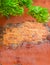 Beautiful broken orange stucco wall with exposed brick in Italy