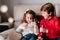 beautiful brother and sister at home playing with garland of lights. Christmas concept