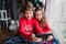 beautiful brother and sister at home taking a selfie with mobile phone. Happy kids sitting by the christmas tree