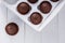 Beautiful brown delicious chocolate muffins in a white box delivery food on wooden background close-up