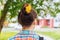 Beautiful brown hair of a young girl with dandelions. A beautiful girl has woven flowers into her hair. Romantic female hairstyle.