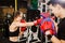 A beautiful brown haired Asian woman practicing boxing with an Asian male trainer