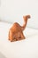 Beautiful brown varnished wooden dromedary camel miniature sitting down