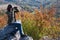 Beautiful brunette with binoculars watching autumn nature