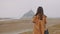 Beautiful brunette blogger woman smiling at camera, taking picture of epic foggy Mont Saint Michel Island slow motion.