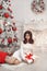 Beautiful brunette in Christmas interior. Elegant winter woman i