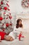 Beautiful brunette in Christmas interior. Elegant winter woman i