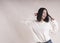 Beautiful brunette girl braces happy white sweater, dancing, emotion