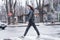 Beautiful brunette girl crosses the road on a pedestrian crossing.