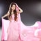 Beautiful brunette girl model in blowing transparent chiffon dress. Long wavy hair styling.