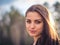 A beautiful brunette girl posing in a field on autumn. Art photo